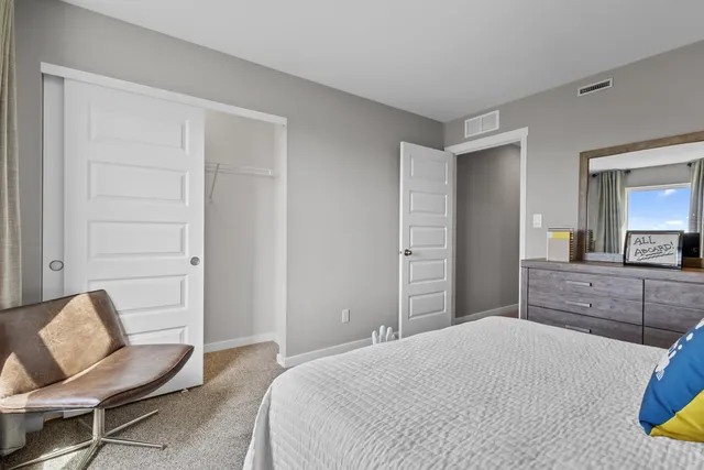 a bedroom with a bed and chair