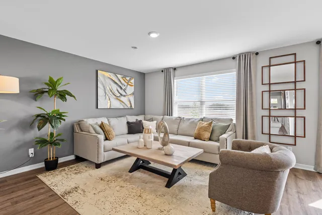 a living room with furniture and a large window