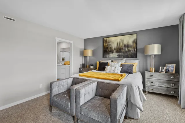 a bedroom with a bed and a lamp