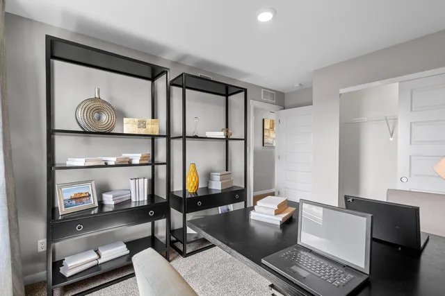 a living room with furniture and a mirror