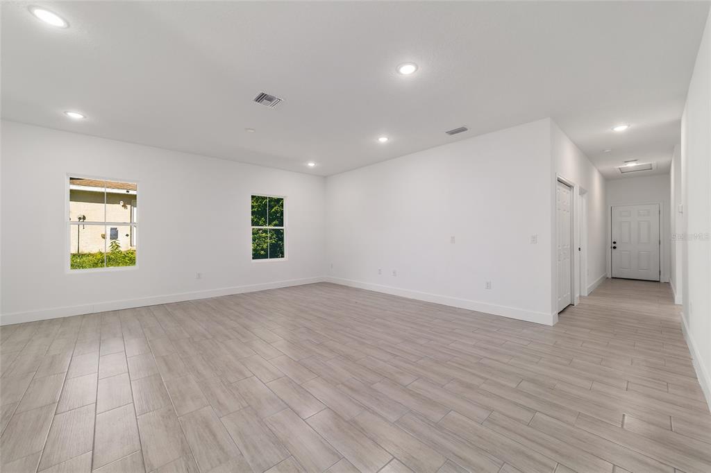 15431 Southwest 41st Street Road Ocala, FL 34481 - Photo 7 of 44 an empty room with wooden floor and windows