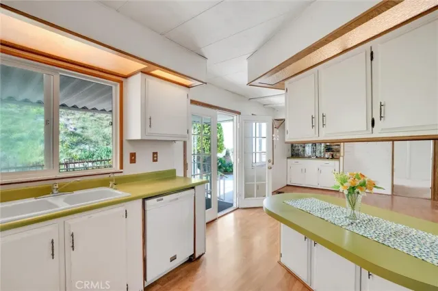a kitchen with white cabinets and white appliances