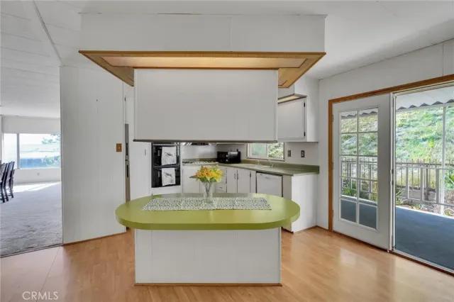 a view of kitchen with furniture and wooden floor