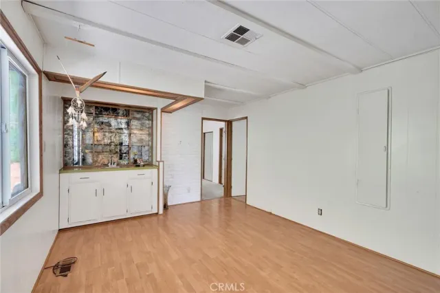 a bedroom with a bed and a large mirror