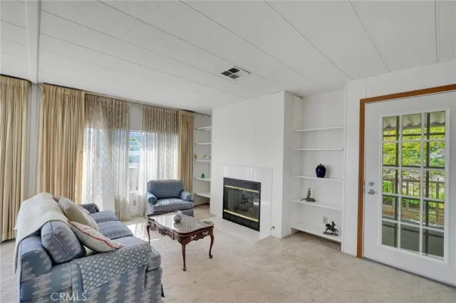 a living room with furniture a fireplace and a table