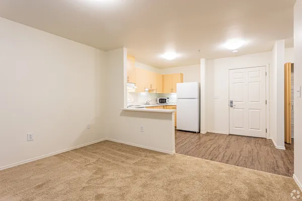 a view of a kitchen with a sink and a refrigerator