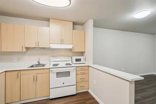 a white refrigerator freezer sitting inside of a kitchen