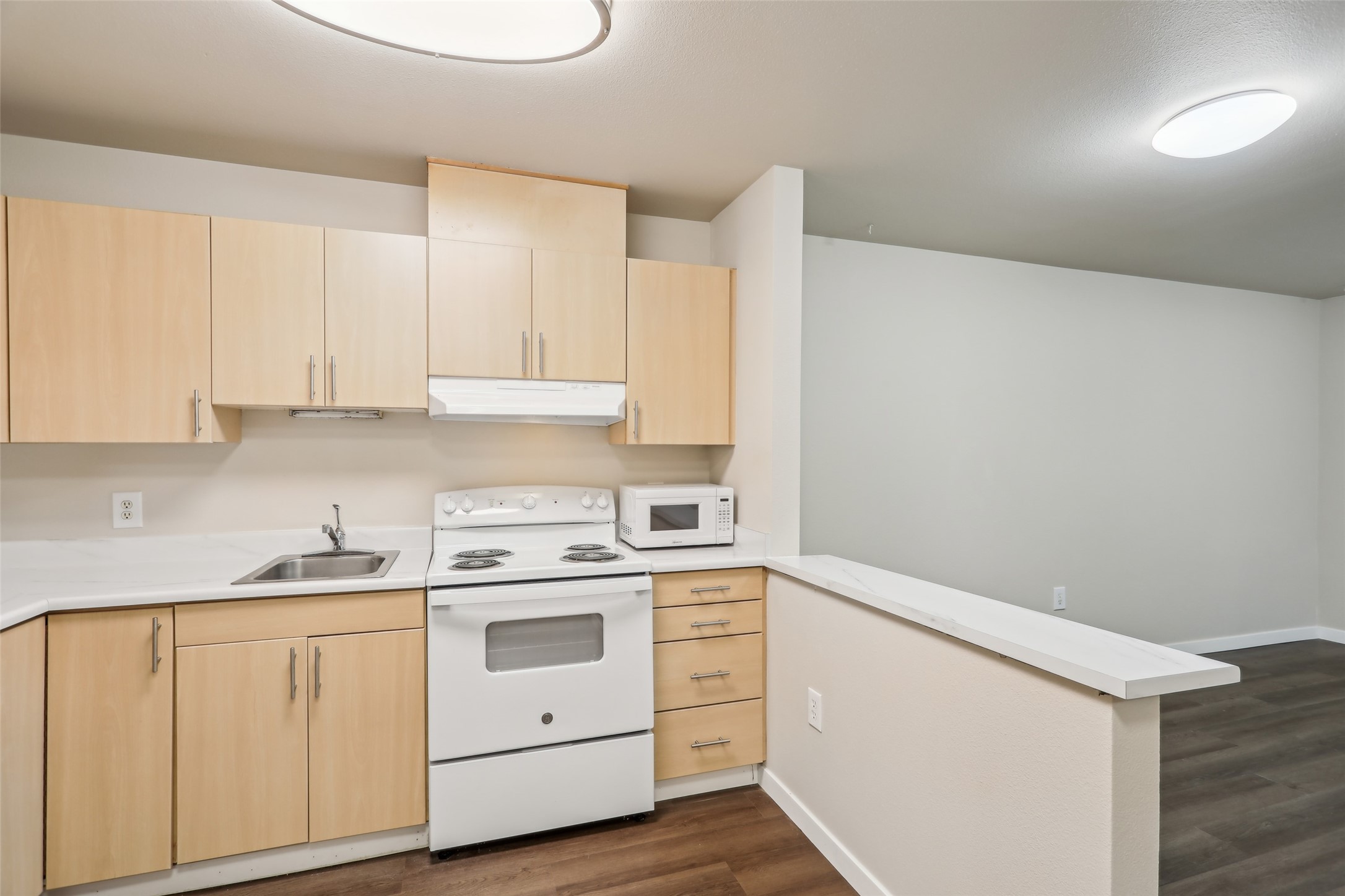 6940 37th Avenue South Seattle, WA 98118 - Photo 34 of 50 a kitchen with white cabinets and white appliances