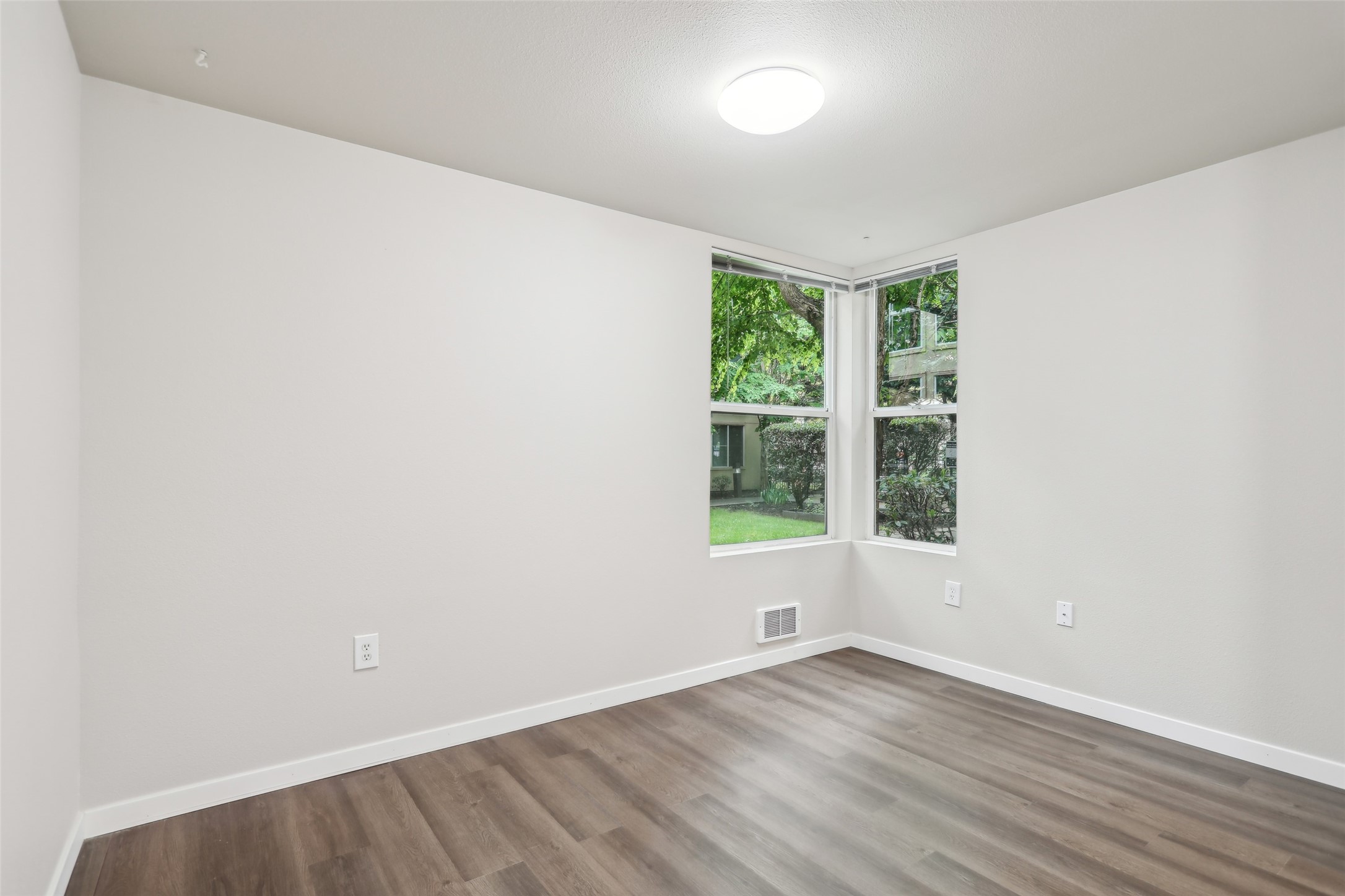 6940 37th Avenue South Seattle, WA 98118 - Photo 37 of 50 an empty room with wooden floor and windows