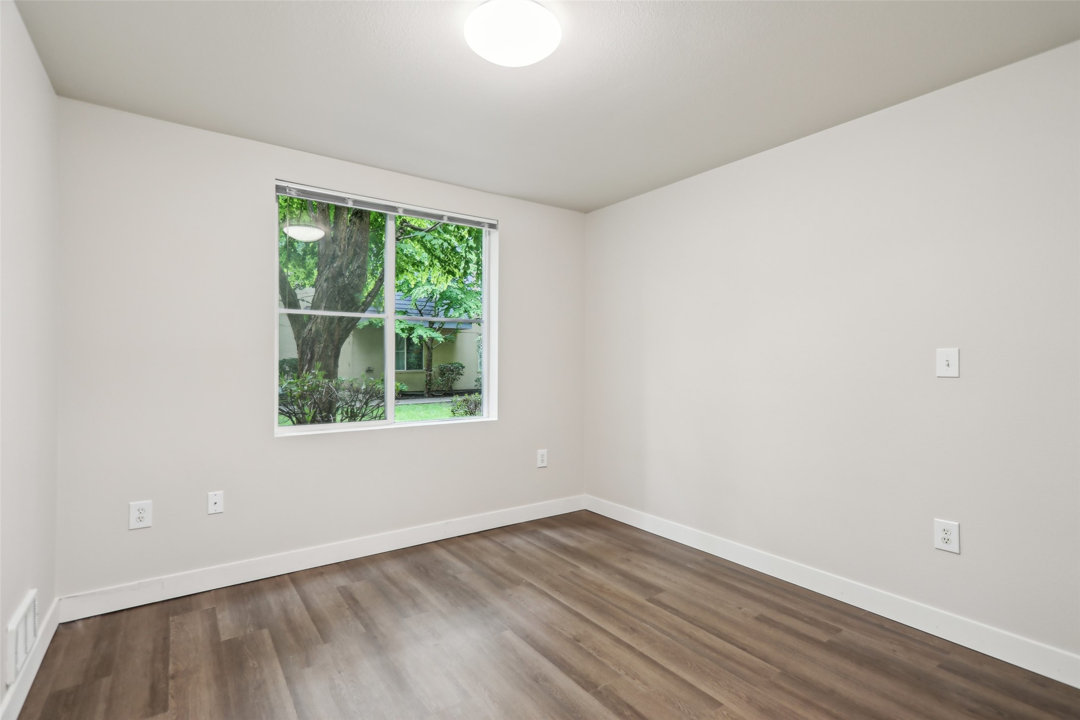 6940 37th Avenue South Seattle, WA 98118 - Photo 39 of 50 a view of an empty room with wooden floor and a window