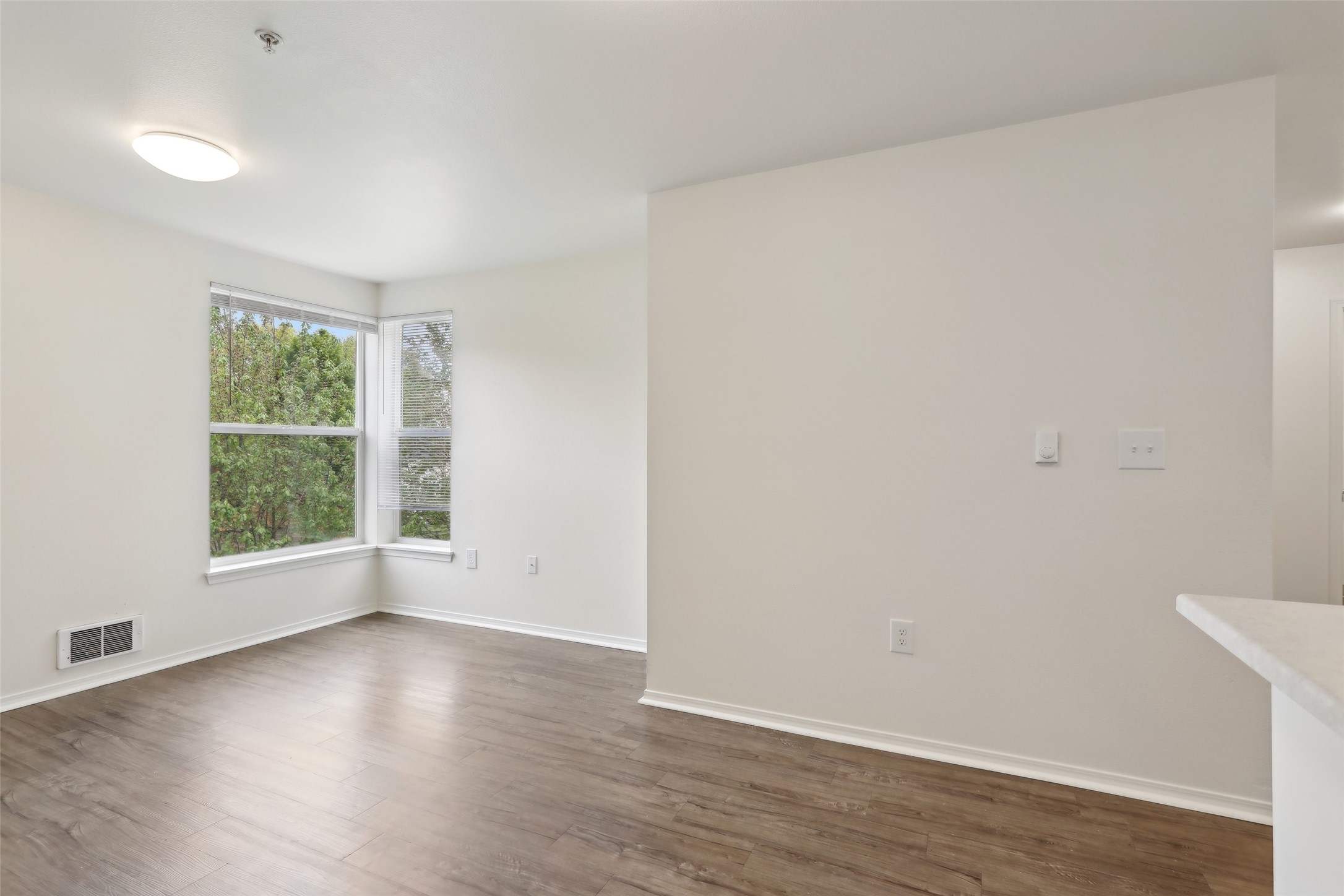 6940 37th Avenue South Seattle, WA 98118 - Photo 46 of 50 an empty room with wooden floor and windows