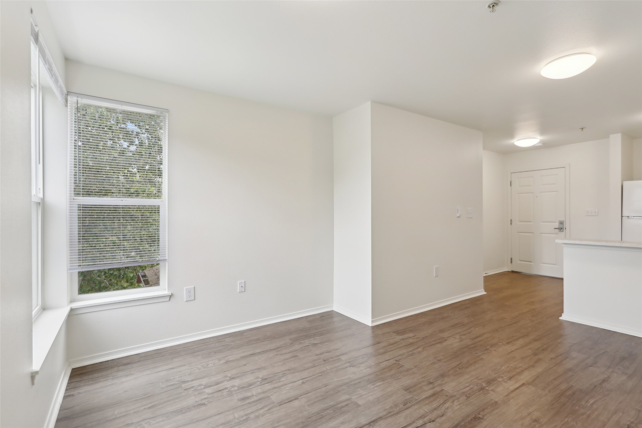 6940 37th Avenue South Seattle, WA 98118 - Photo 47 of 50 a view of an empty room with wooden floor and a window