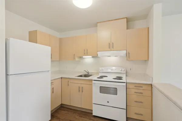 a kitchen with white cabinets and white appliances