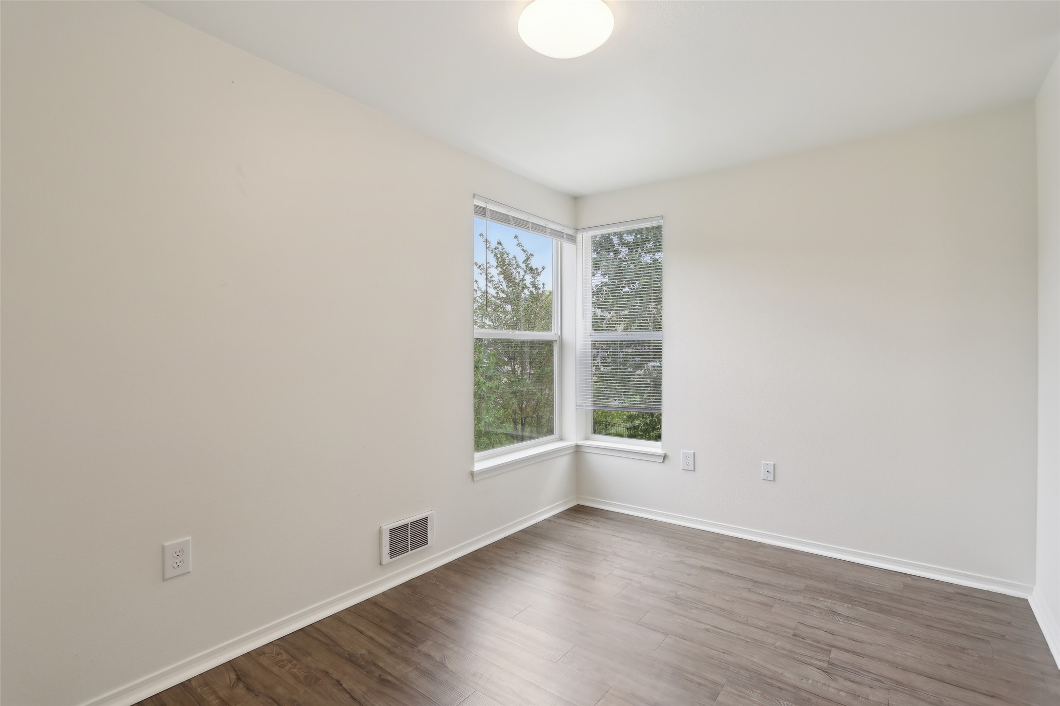 6940 37th Avenue South Seattle, WA 98118 - Photo 50 of 50 an empty room with wooden floor and windows