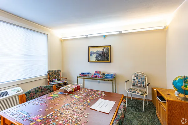 a bed room with a bed and a chair