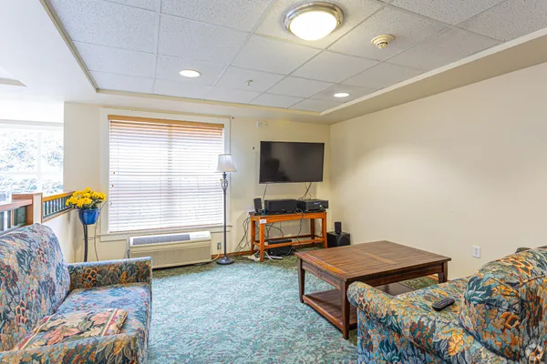 a bedroom with furniture and a flat screen tv