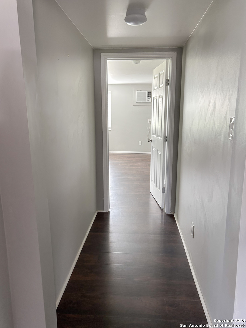 613 East Ireland Street Seguin, TX 78155 - Photo 19 of 42 a view of a hallway with wooden floor
