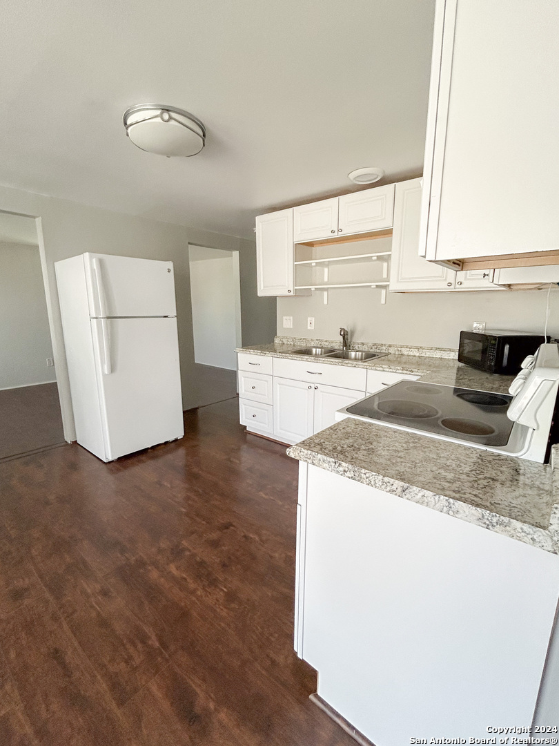 613 East Ireland Street Seguin, TX 78155 - Photo 24 of 42 a kitchen with a stove a refrigerator and a sink