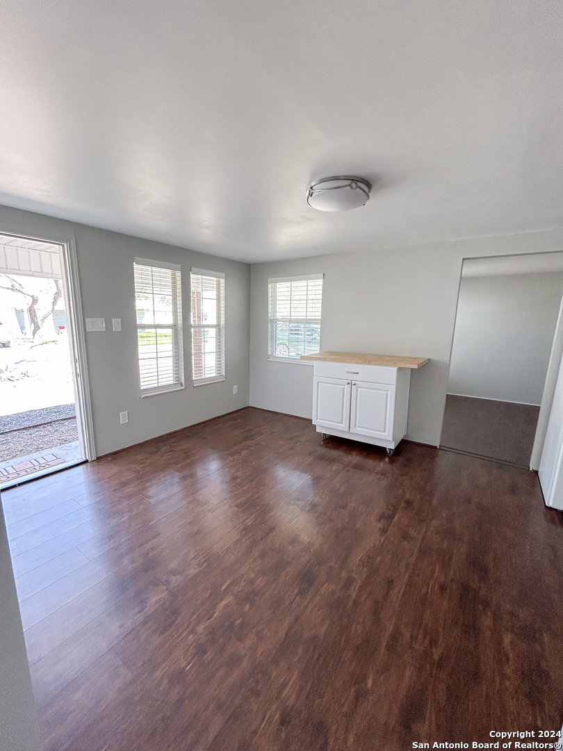 613 East Ireland Street Seguin, TX 78155 - Photo 30 of 42 wooden floor in an empty room with a window