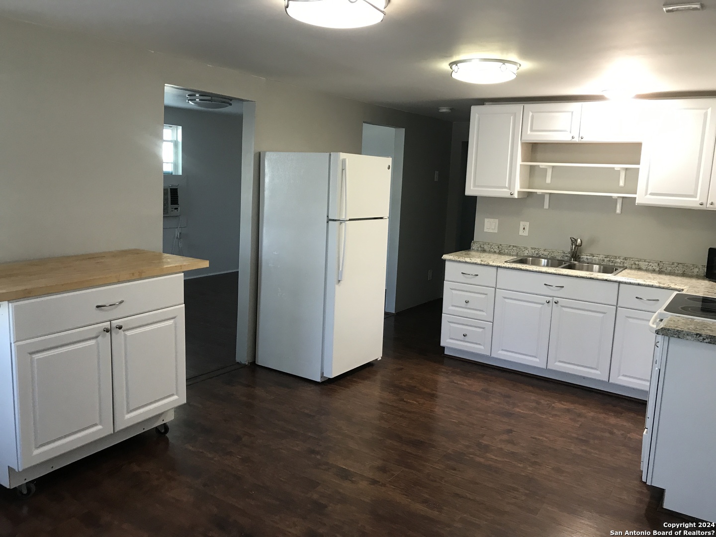 613 East Ireland Street Seguin, TX 78155 - Photo 3 of 42 a kitchen with white cabinets and white appliances