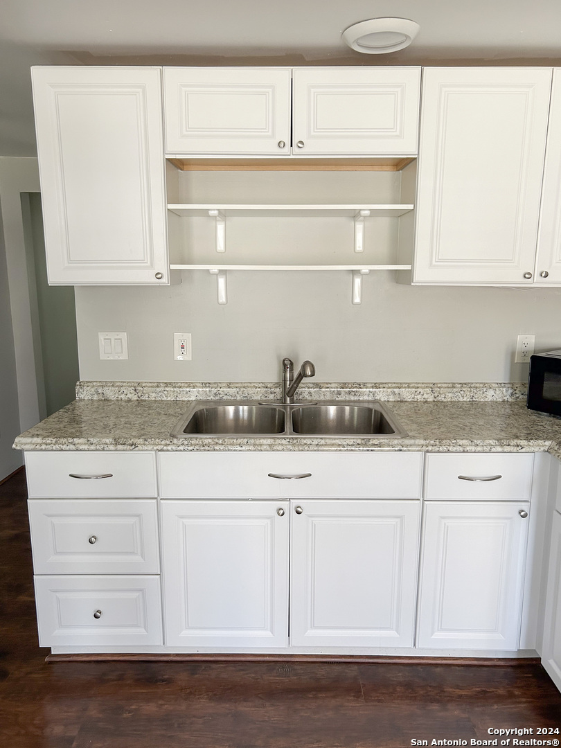 613 East Ireland Street Seguin, TX 78155 - Photo 31 of 42 a kitchen with white cabinets and sink