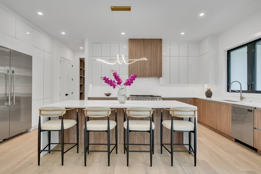 8 Winston Road Lexington, MA 02421 - Photo 16 of 42 a kitchen with a table and chairs in it