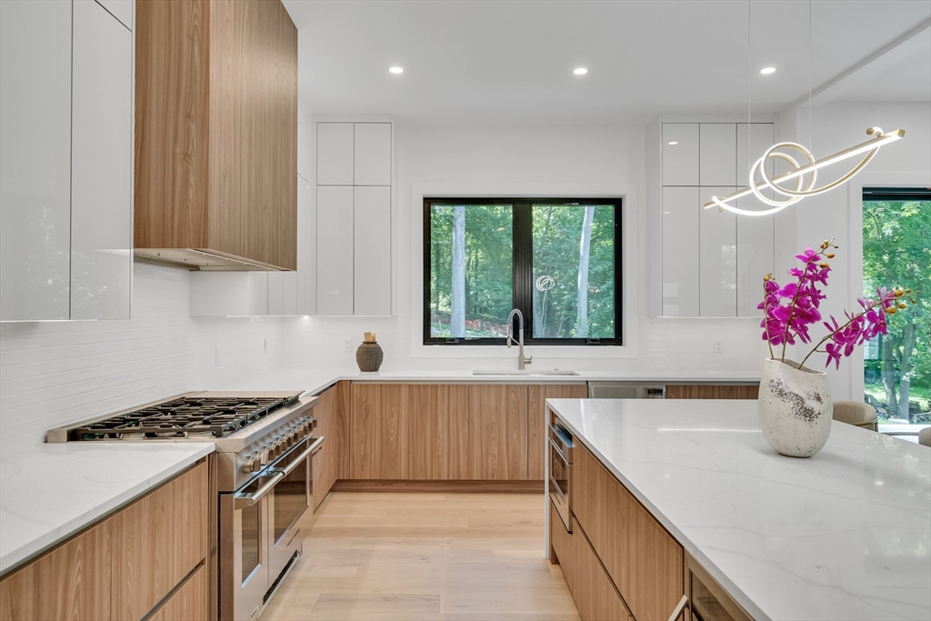8 Winston Road Lexington, MA 02421 - Photo 19 of 42 a kitchen with a sink stove and cabinets