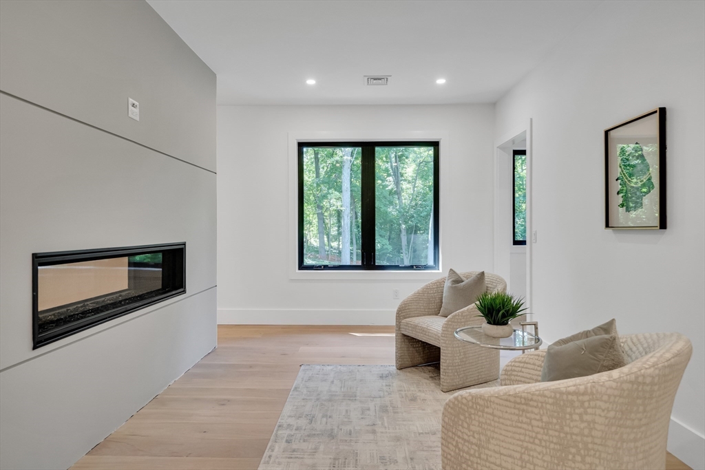 8 Winston Road Lexington, MA 02421 - Photo 24 of 42 a living room with furniture and a flat screen tv