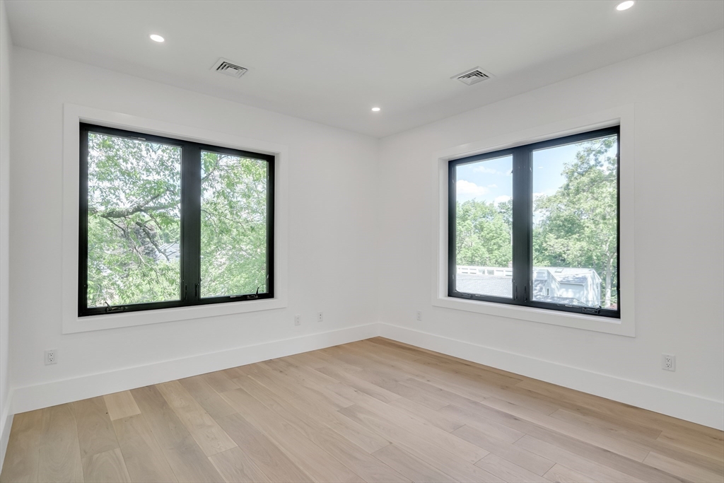 8 Winston Road Lexington, MA 02421 - Photo 31 of 42 a view of an empty room with wooden floor and a window