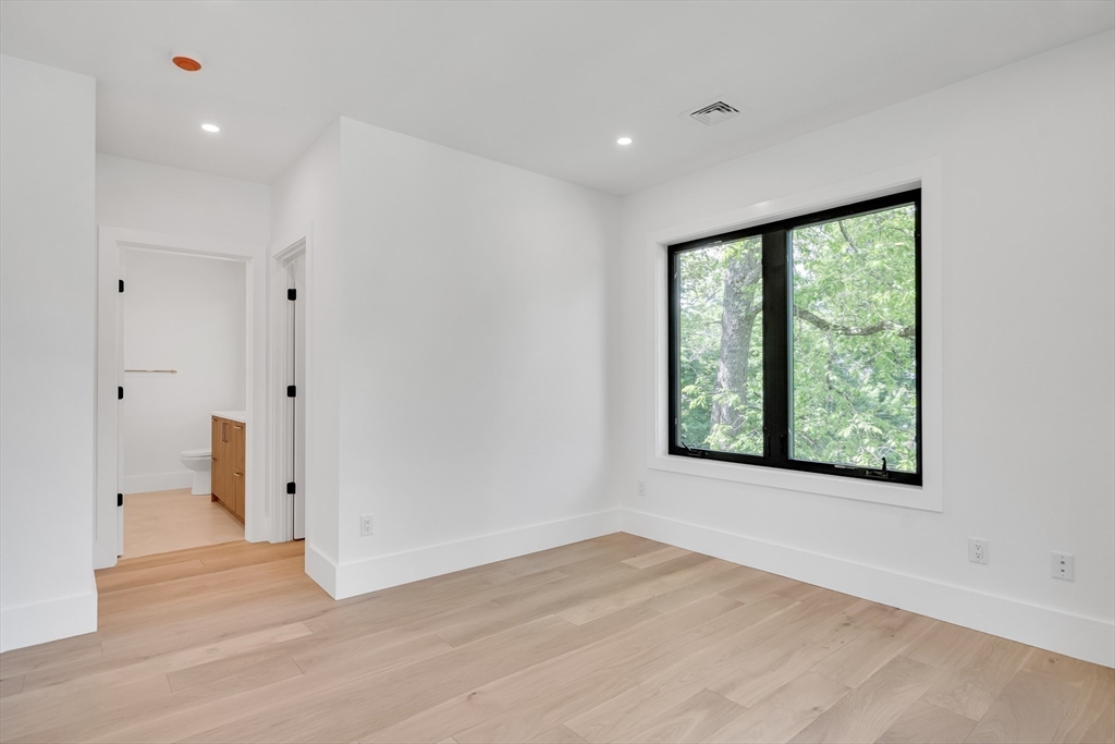 8 Winston Road Lexington, MA 02421 - Photo 33 of 42 a view of an empty room with wooden floor and a window