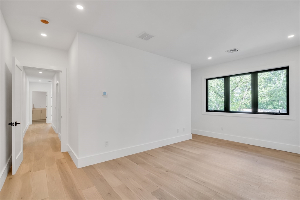8 Winston Road Lexington, MA 02421 - Photo 34 of 42 wooden floor in an empty room with a window