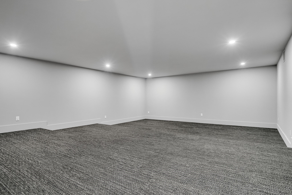 8 Winston Road Lexington, MA 02421 - Photo 35 of 42 an empty room with wooden floor and windows