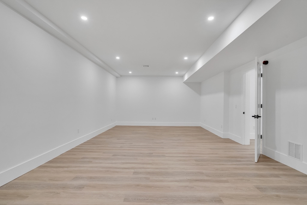 8 Winston Road Lexington, MA 02421 - Photo 36 of 42 a view of empty room with wooden floor and fan