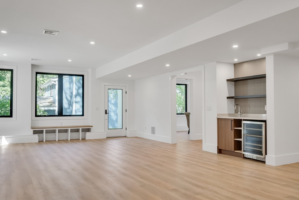 8 Winston Road Lexington, MA 02421 - Photo 37 of 42 an empty room with wooden floor and windows