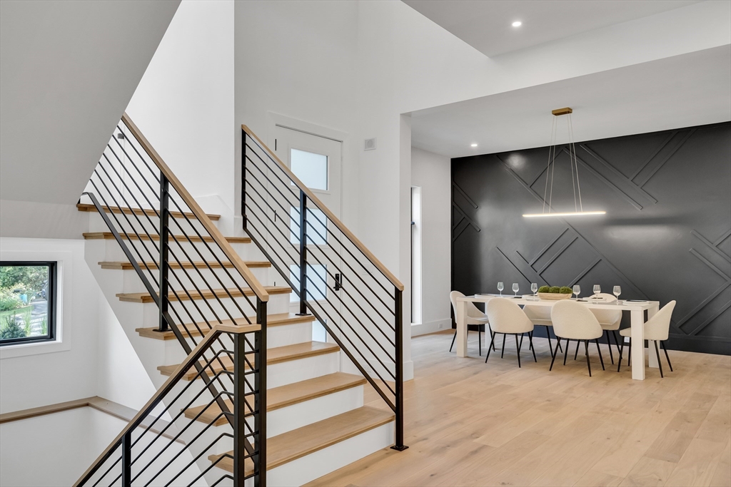 8 Winston Road Lexington, MA 02421 - Photo 6 of 42 a dining room with a wooden table and chairs