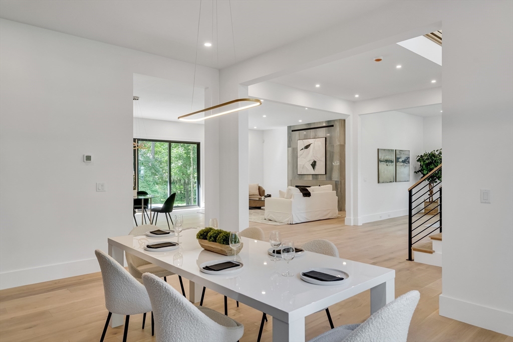 8 Winston Road Lexington, MA 02421 - Photo 9 of 42 a view of a dining room with furniture and a potted plant