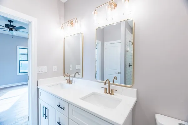 a bathroom with a sink vanity and a mirror
