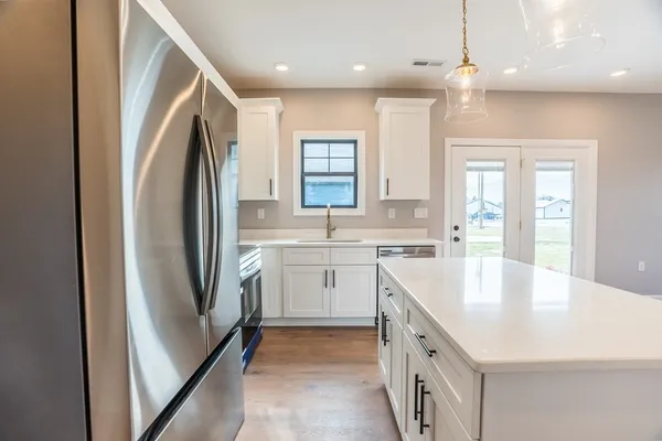 a kitchen with a sink stove and refrigerator