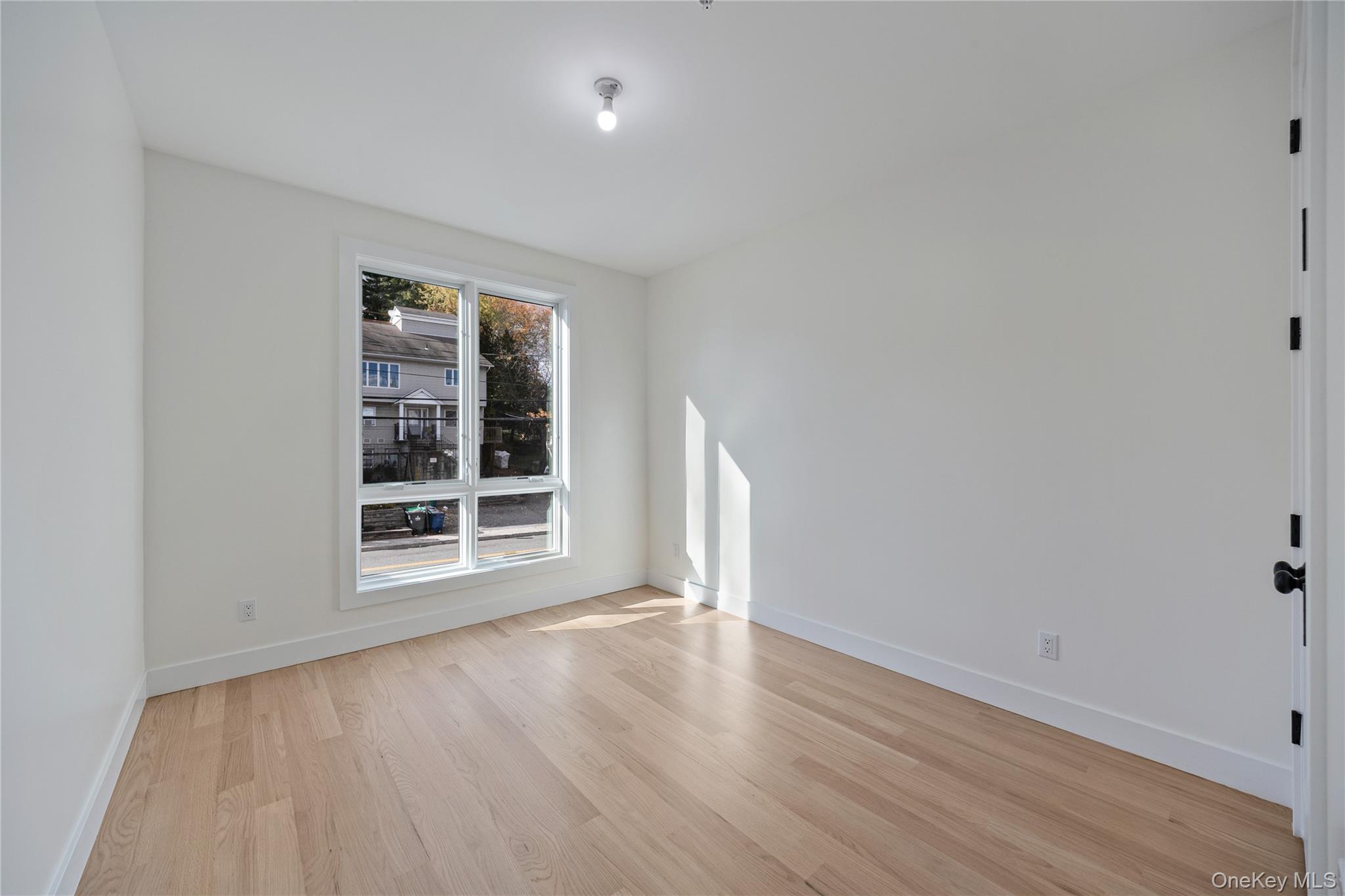 352 Blauvelt Road, Unit 202 Monsey, NY 10952 - Photo 14 of 33 an empty room with wooden floor and windows