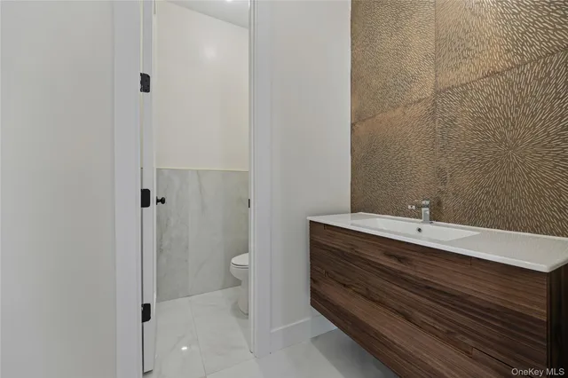 a view of a hallway with staircase and white walls