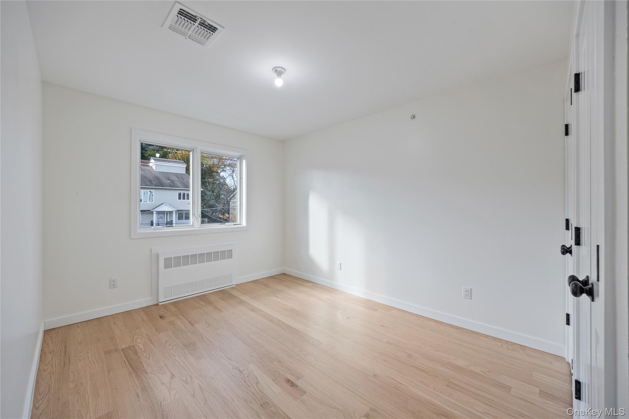 352 Blauvelt Road, Unit 202 Monsey, NY 10952 - Photo 27 of 33 an empty room with wooden floor and windows