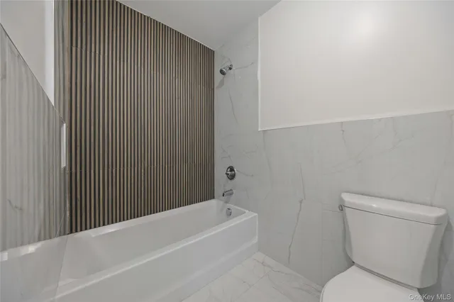 a view of an empty room and wooden floor