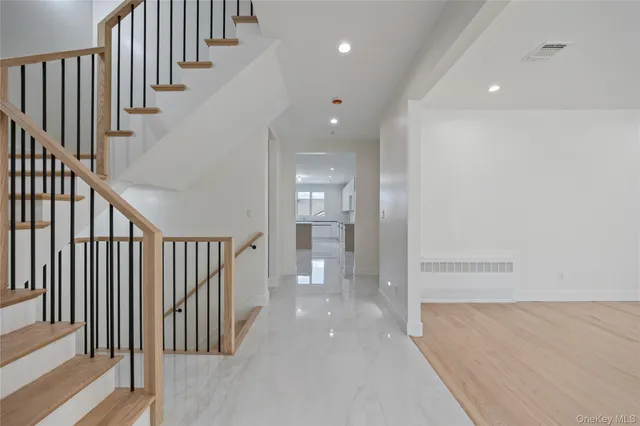 a view of empty room with wooden floor and windows