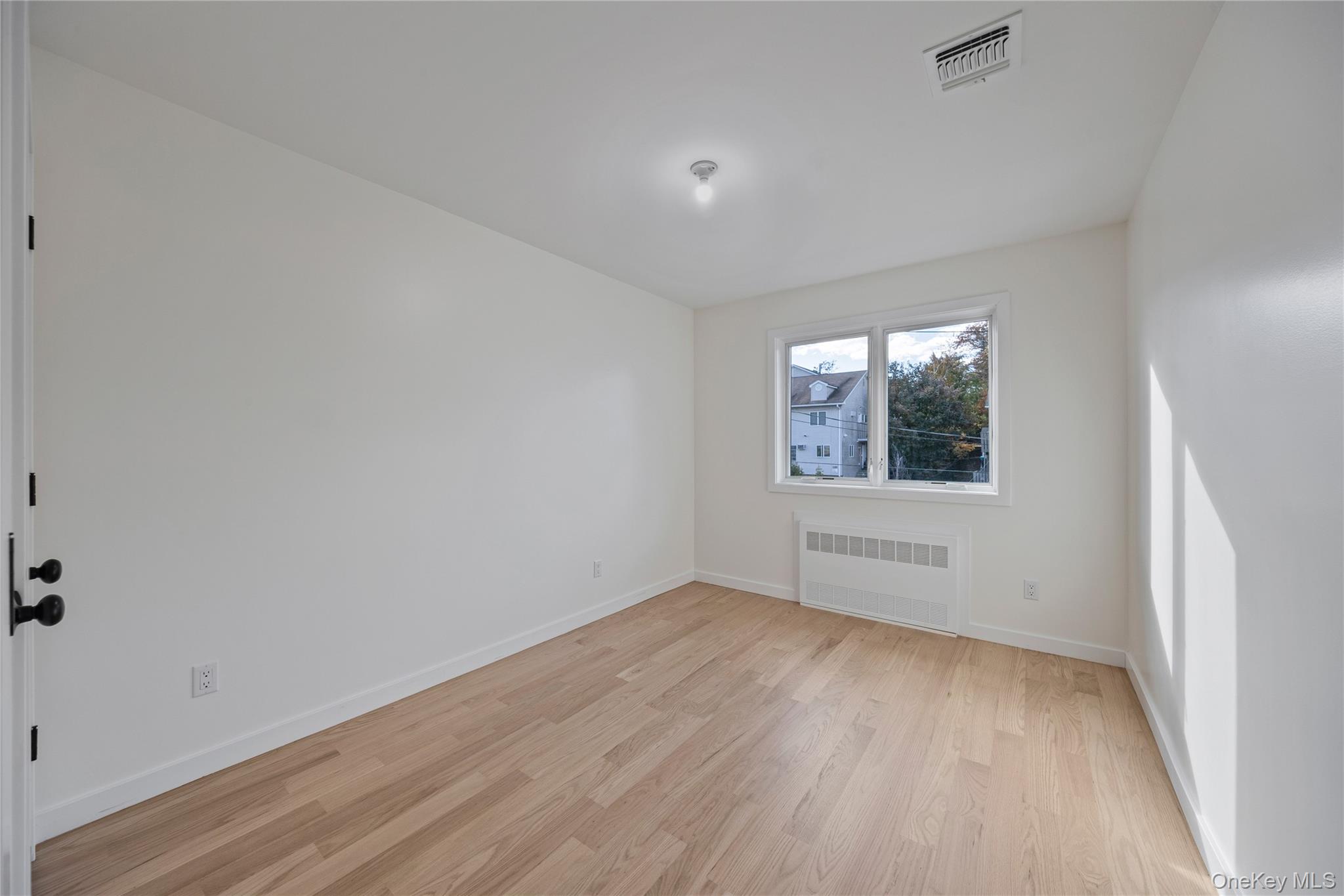 352 Blauvelt Road, Unit 202 Monsey, NY 10952 - Photo 31 of 33 an empty room with wooden floor and windows