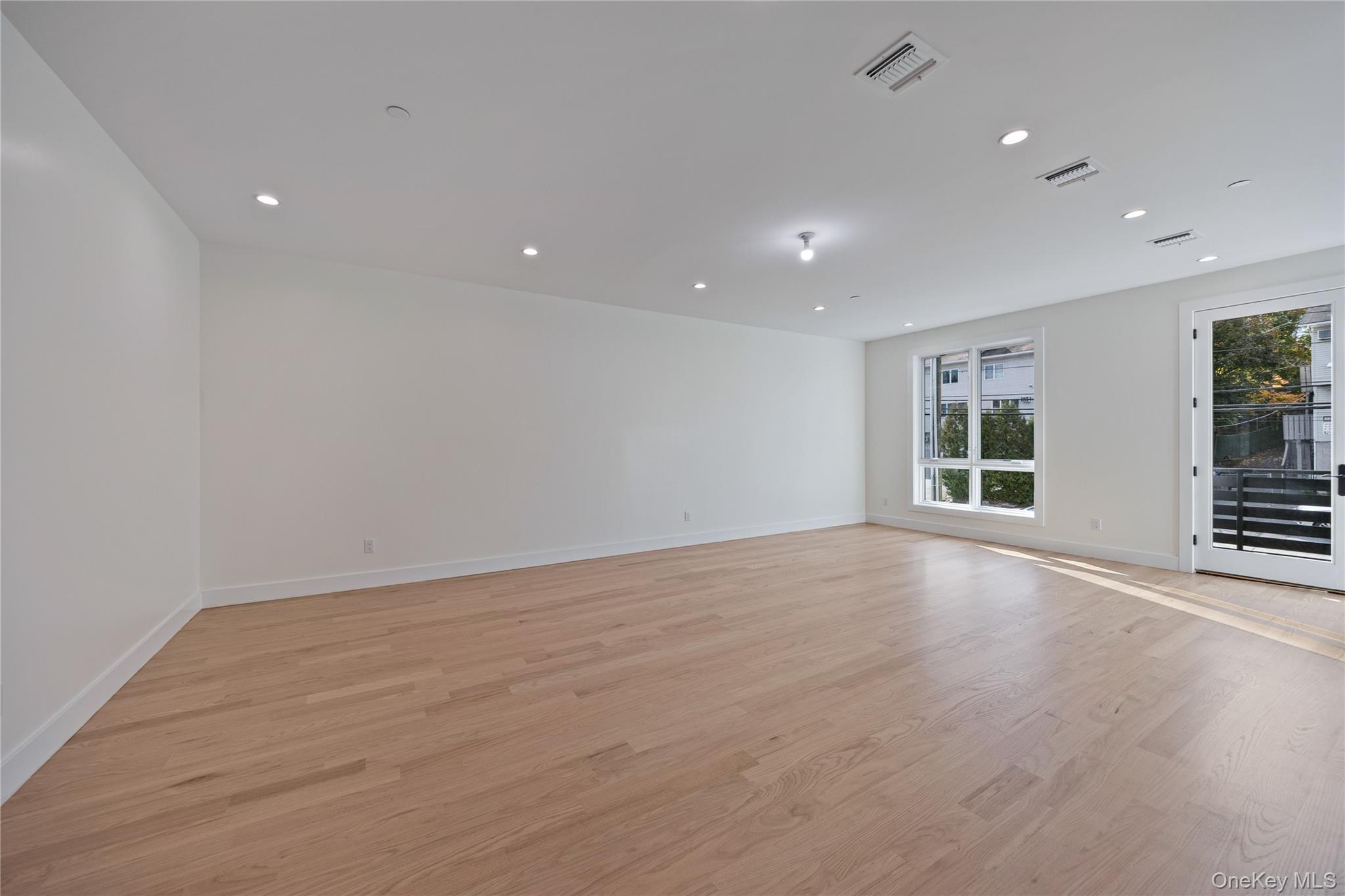352 Blauvelt Road, Unit 202 Monsey, NY 10952 - Photo 5 of 33 an empty room with wooden floor and windows