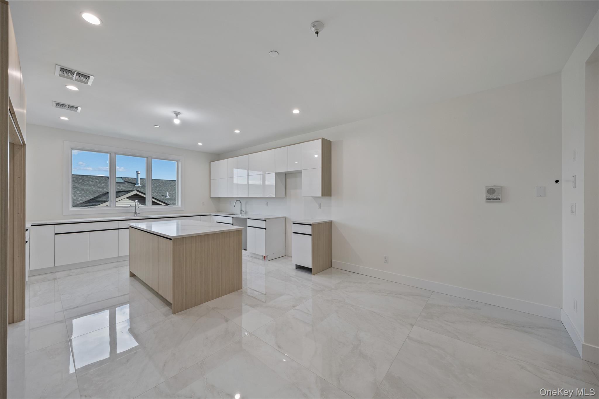 352 Blauvelt Road, Unit 202 Monsey, NY 10952 - Photo 7 of 33 a kitchen with white cabinets and stainless steel appliances