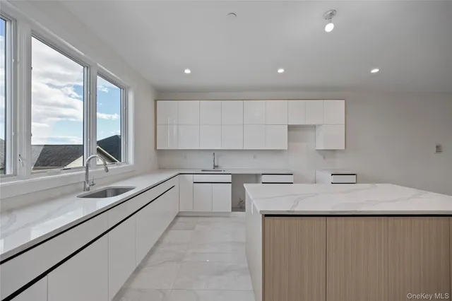 a kitchen with a sink stove top oven and cabinets