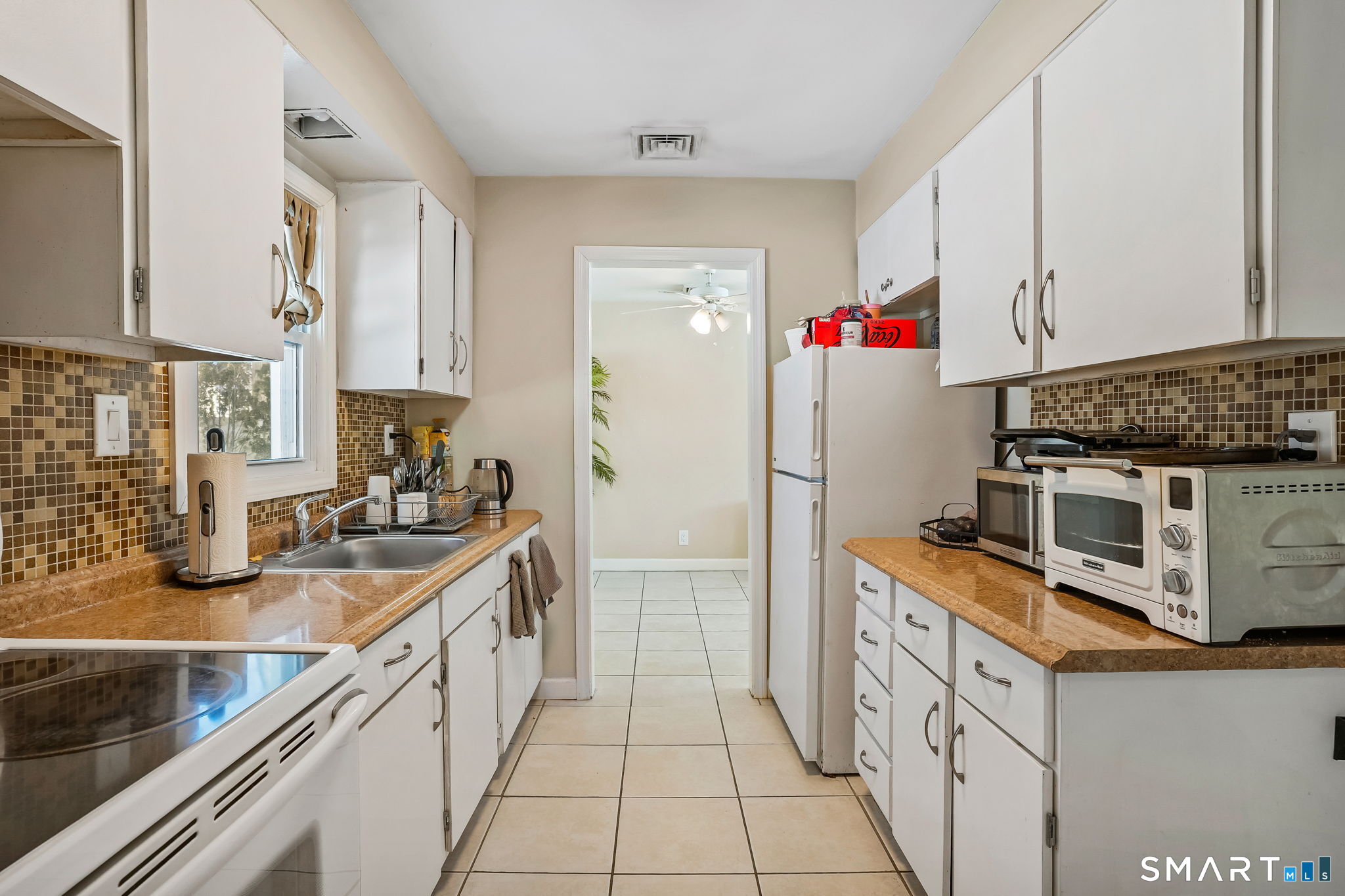 3460 Old Town Road Bridgeport, CT 06606 - Photo 13 of 34 a kitchen with stainless steel appliances granite countertop a sink stove and refrigerator