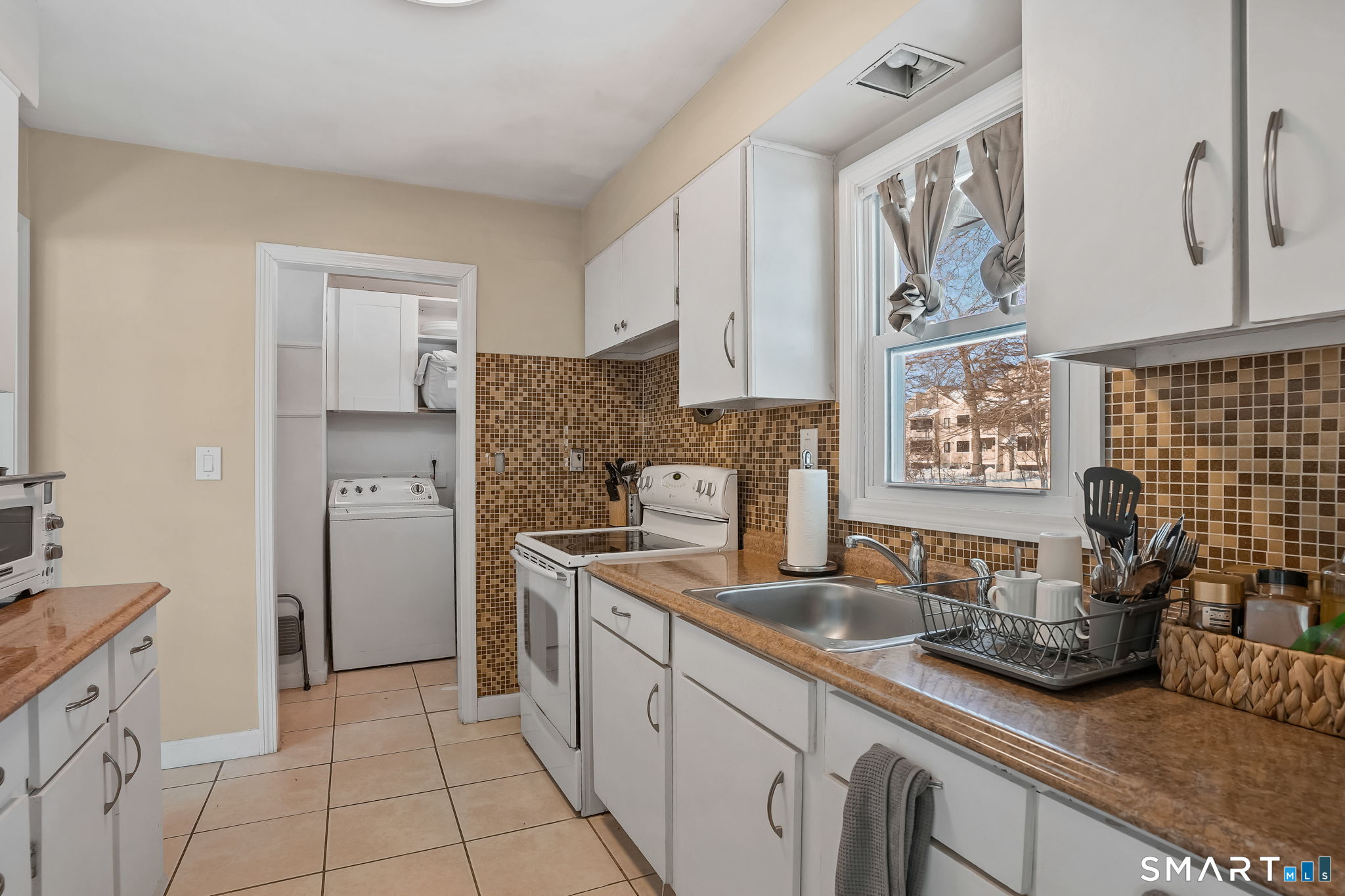 3460 Old Town Road Bridgeport, CT 06606 - Photo 14 of 34 a kitchen with stainless steel appliances a sink dishwasher stove refrigerator and cabinets