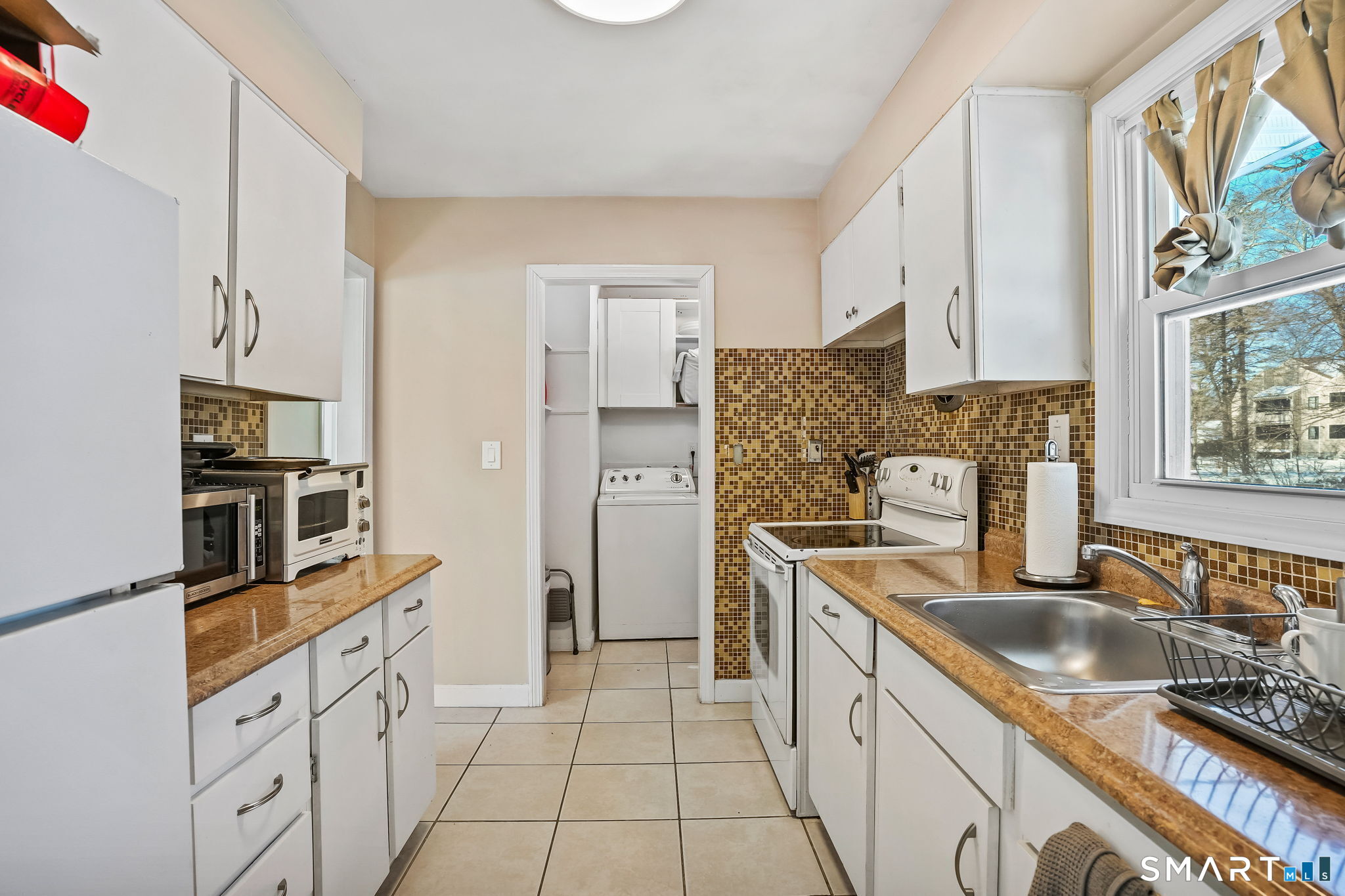 3460 Old Town Road Bridgeport, CT 06606 - Photo 15 of 34 a kitchen with stainless steel appliances granite countertop a sink stove and refrigerator